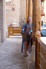 Woman profile portrait at hotel veranda. Concept: Central Asian cultural tourism, Uzbekistan ethnic hospitality, Female mental wellness relaxation. © Anna