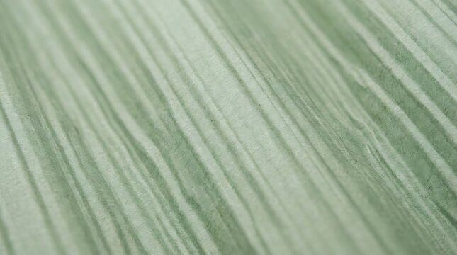 Abstract macro background of green textured paper with vertical parallel lines and soft shadows