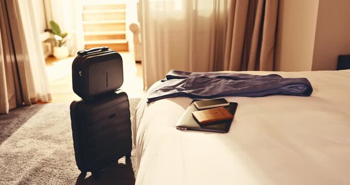 Hotel, travel and luggage in room with bed, passport and laptop electronics with phone on holiday. Resort, suitcase and accommodation interior for hospitality, tourism or motel furniture for vacation
