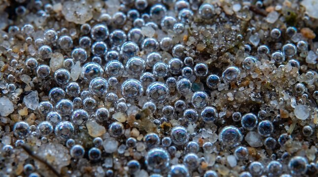 Close up of water droplets on wet sand and gravel