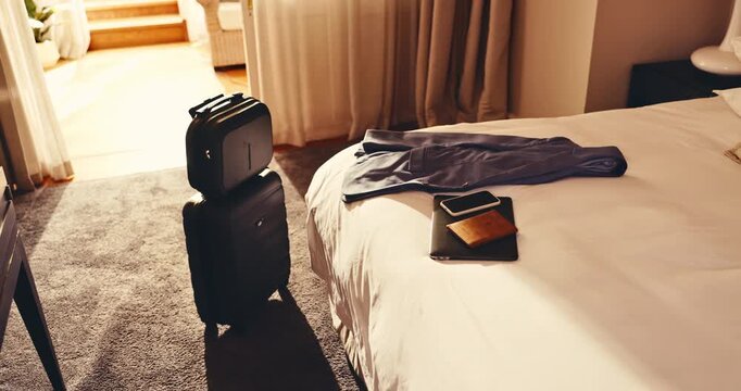 Hotel, travel and suitcase in room with bed, passport and laptop electronics with phone on holiday. Resort, luggage and accommodation interior for hospitality, tourism or motel furniture for vacation