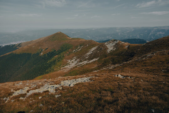 Rugged peaks and dramatic rocky ridges of the Parang mountain range in late summer.