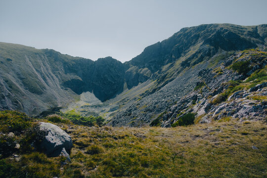 Panoramic view of a deep mountain valley carved by ancient glacial activity.
