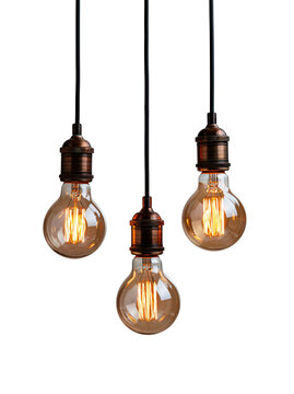 Three vintage Edison light bulbs hanging from black cords against a white background