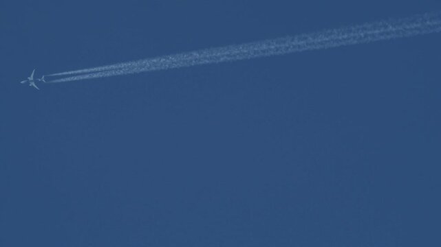 Jet Airplane Leaving Long White Contrail Across Clear Blue Sky