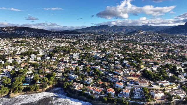 Aerial Suburban Neighborhood Rows Of Houses With Tiled Roofs And Gardens, Coastal Villas Hugging Cliff Edge,