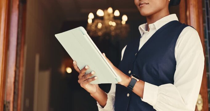 Woman, receptionist and hands with tablet at front door for hotel, travel or booking accommodation. Lobby, concierge and digital tech for guest, reservation and customer service for hospitality