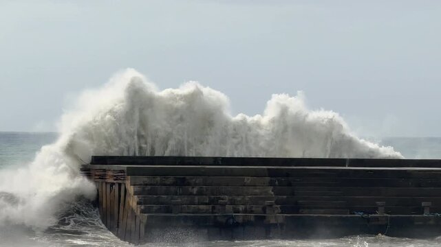 Massive Breaking Wave Slams Into Sea Wall During Rough Weather