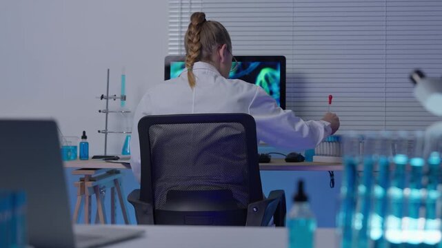 Female scientist working on computer in laboratory