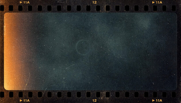 Vintage film strip frame shows empty dark negative with warm light leak and heavy dust. Analog texture creates nostalgic mood, with sprocket holes and faded grain across transparent center.