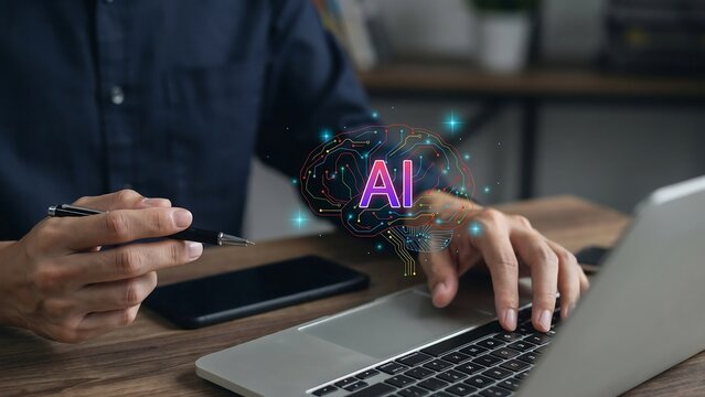 Man working on laptop with glowing artificial intelligence brain hologram graphic concept