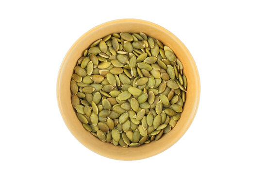 Pumpkin seeds in a bowl isolated on a white background. Rich in omega-3 and omega-6 fatty acids. Contains amino acid tryptophan. Rich in protein. Top view.