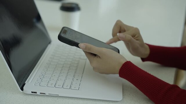 Close-up of hands typing on a laptop keyboard in a warm home workspace, representing remote work, productivity, online business, and digital technology.