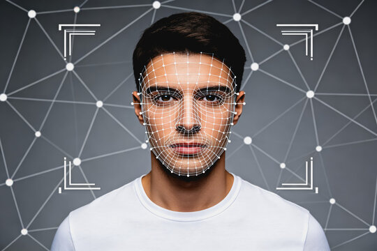 A young man's face is scanned with a digital grid for facial recognition and biometric identification technology.