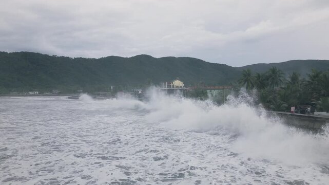 Drone Shot Large Storm Waves Crashing Into Sea Defense Along Coast