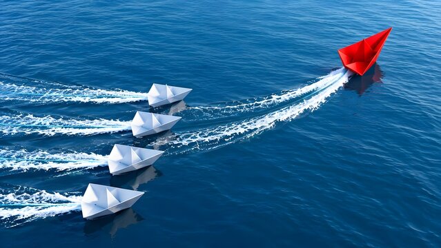 Red paper boat leading a fleet of white boats on blue water concept for leadership and standing out from the crowd