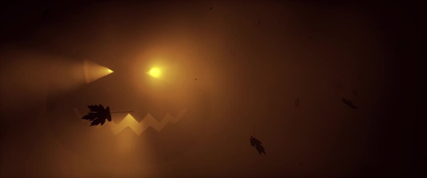 Glowing Halloween jack-o-lantern face in brown fog with falling autumn leaves silhouettes. Spooky pumpkin glow atmospheric horror holiday background. Seamless loop 3d rendering animation.