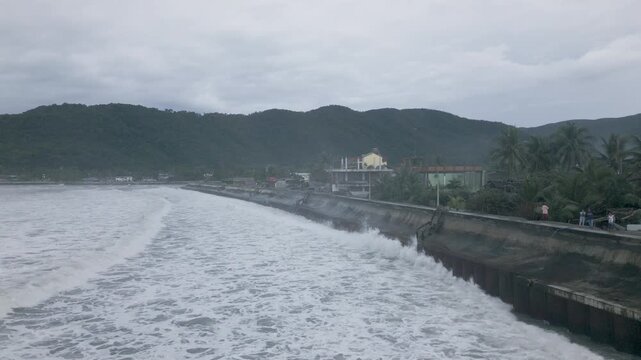 Aerial View Of Powerful Storm Tide Waves Pounding Coastal Sea Wall