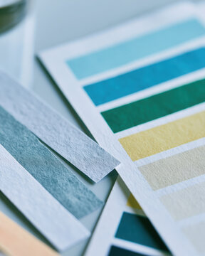 pH paper color chart comparison for acidity measurement laboratory macro  