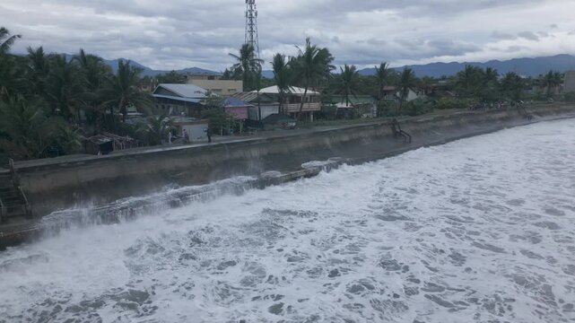 Large Ocean Waves Crash Against Sea Defense Along Tropical Coast