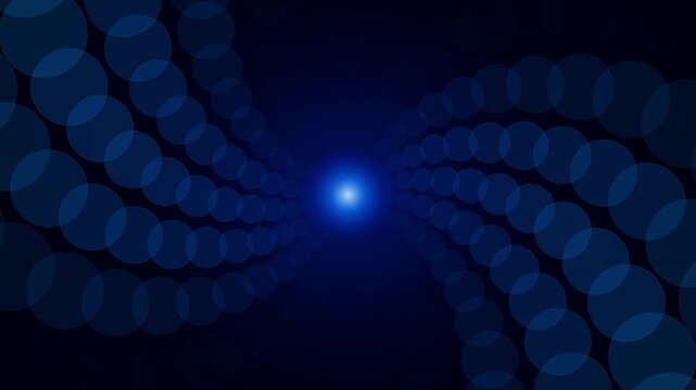 Abstract blue bokeh circles and glowing central light ray flare swirling in graceful symmetrical curved paths over dark background for digital technology backdrop
