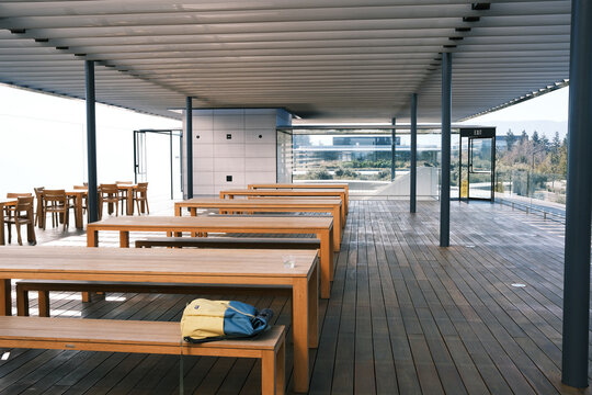 Empty Modern Rooftop Terrace With Wooden Tables and Benches
