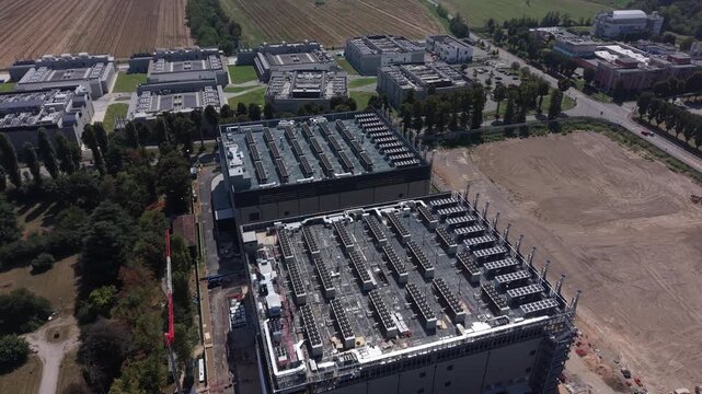Aerial view of the DC 11 data center construction site by Generale Prefabbricati, featuring large industrial buildings and cooling units in Castelletto, Lombardia, Italy.
