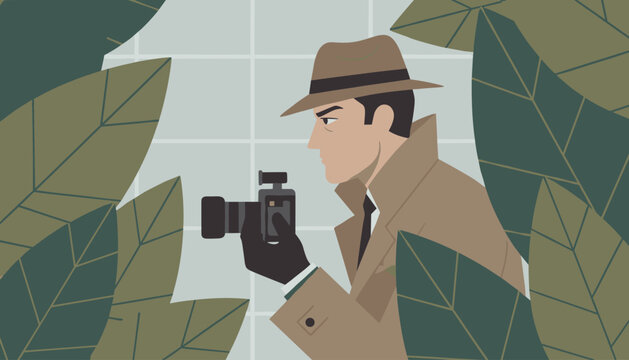 Private detective in a trench coat and fedora hat hiding behind green tropical leaves to secretly take a photo.