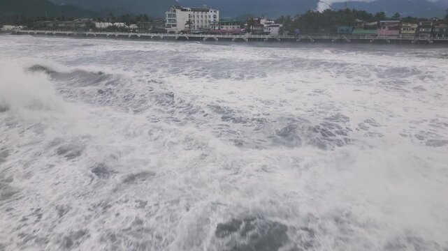 Aerial View Of Fast Moving Storm Surge Waves Rushing Toward Coastline