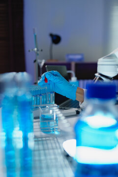 Scientist's hand using pipette during laboratory research