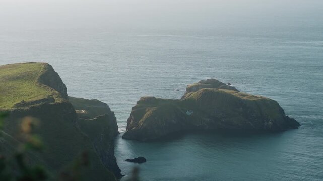 Scenic view of the Antrim Coast near Carrick-a-Rede, with dramatic cliffs, green coastal landscape and the Atlantic Ocean along Northern Ireland famous Causeway Coast - County Antrim 