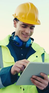 Construction worker, typing and man with tablet, outdoor and laughing with research for renovation. Safety coordinator, scroll and happy person with tech, online and reading digital report on website