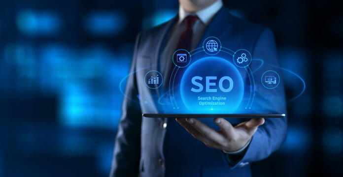 Businessman holding tablet with Search Engine Optimization SEO icons on screen - Digital Marketing Concept