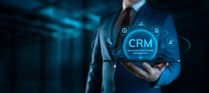 Businessman holding tablet with CRM Customer Relationship Management icons on screen