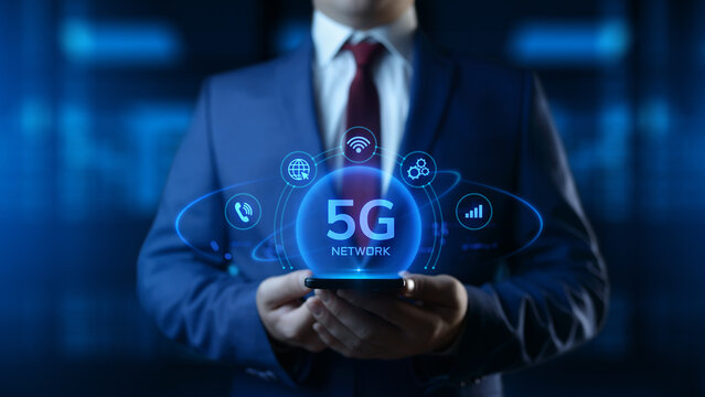 Businessman Holding Smartphone with 5G Network Icons on Screen. Business and Technology concept