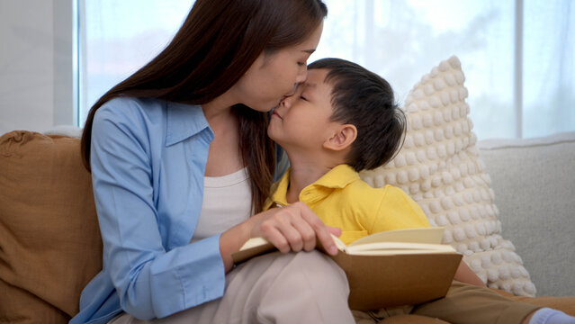 Mother reading a book with her child in a warm home setting