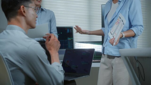 UX designer team presenting smartphone application layout and wireframe during a business meeting in a modern tech office