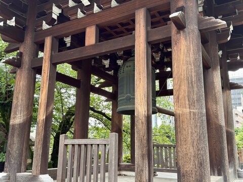 Traditional Japanese temple bell inside a wooden bell tower