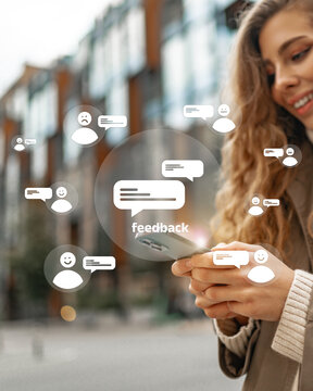 Woman provides feedback using a smartphone in an urban setting, demonstrating engagement with others in digital communication