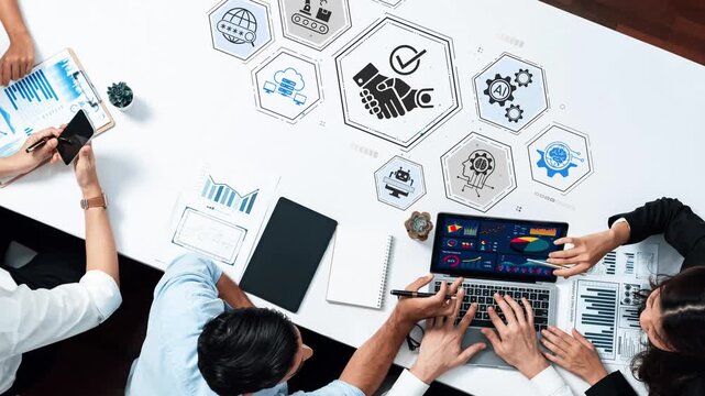 Collaborative Team Meeting Over Table with Digital Devices and Data Visualizations Illustrating Business Strategies and Analytics. Entropy.