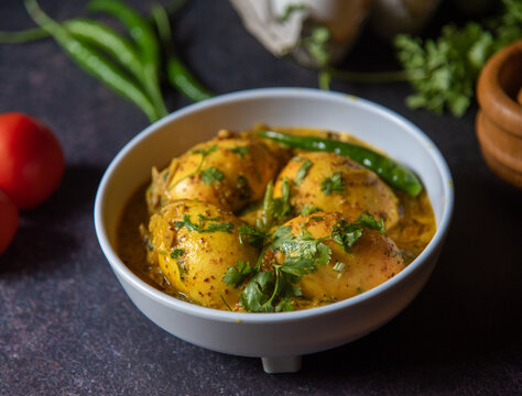 Indian style egg masala in mustard sauce served in a bowl. Close up, selective focus.