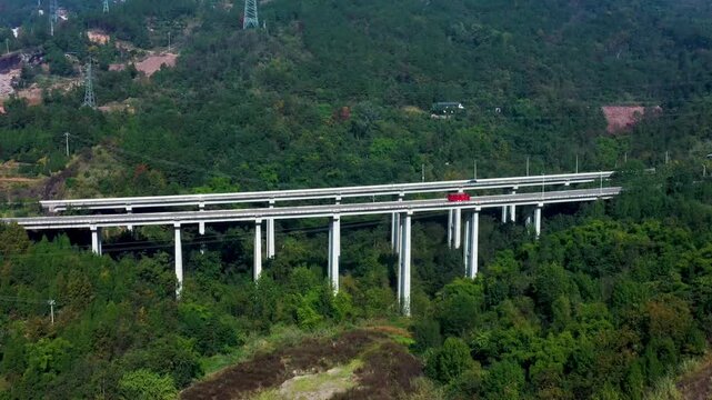 Elevated Highway Bridge Crossing Green Forested Valley and Mountains
