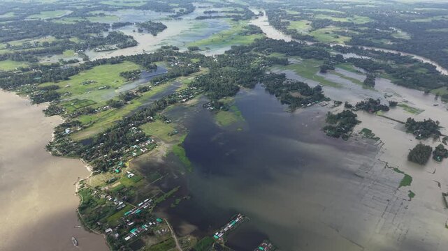 Aerial view of severe river flooding and submerged rural landscape after heavy monsoon rains drone