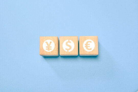 Wooden blocks with yen, dollar, and euro currency symbols represent foreign exchange, global finance, international money markets, investment, banking, and economic trading. concept.