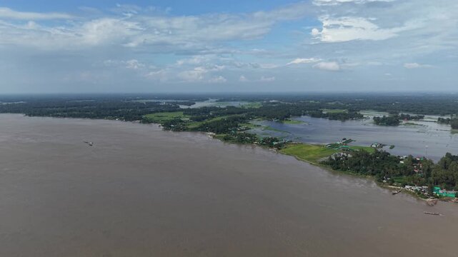 Aerial view of tropical river landscape with lush greenery and rural settlements drone nature