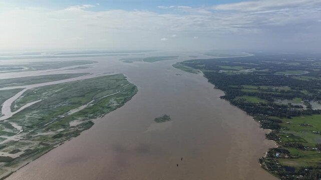Aerial view of wide river delta and lush green landscape, tropical river basin landscape, nature scenery, wide angle drone shot