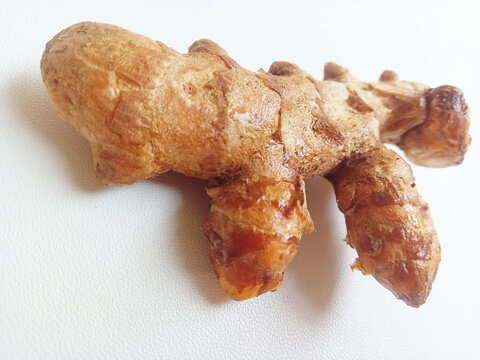 Fresh raw organic turmeric root isolated on a white background