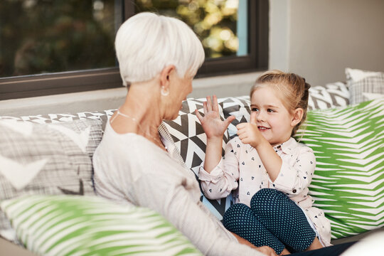 Counting, love and old woman with child on sofa in home for support, bonding and numbers help. Happy, development and math with grandmother and granddaughter in family house for trust and learning