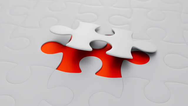 Close up of Orange and White Jigsaw Puzzle Backdrop focusing on the last piece to go into place. Connection Concept.