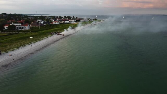 Long sandy shoreline beside calm water at Skt Hans Risskov in Aarhus, Denmark, aerial